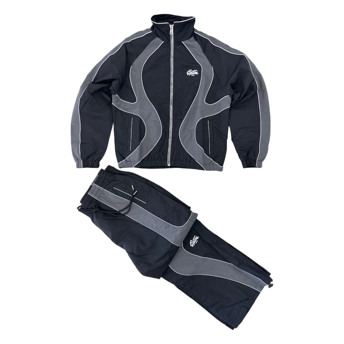 EPTM Syntax track set in black, jacket and pants laid flat