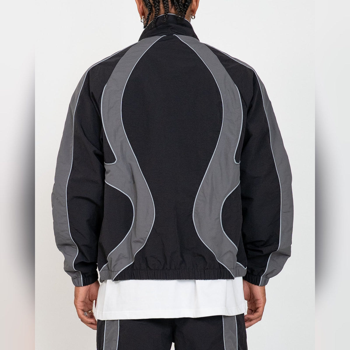 Back of the EPTM Syntax track jacket in black, grey contrast panels