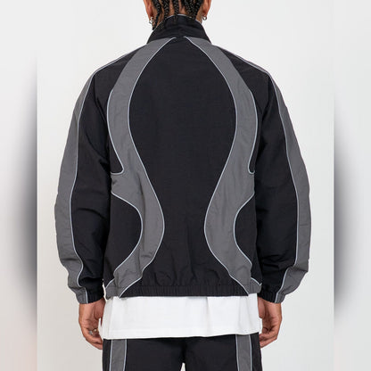 Back of the EPTM Syntax track jacket in black, grey contrast panels