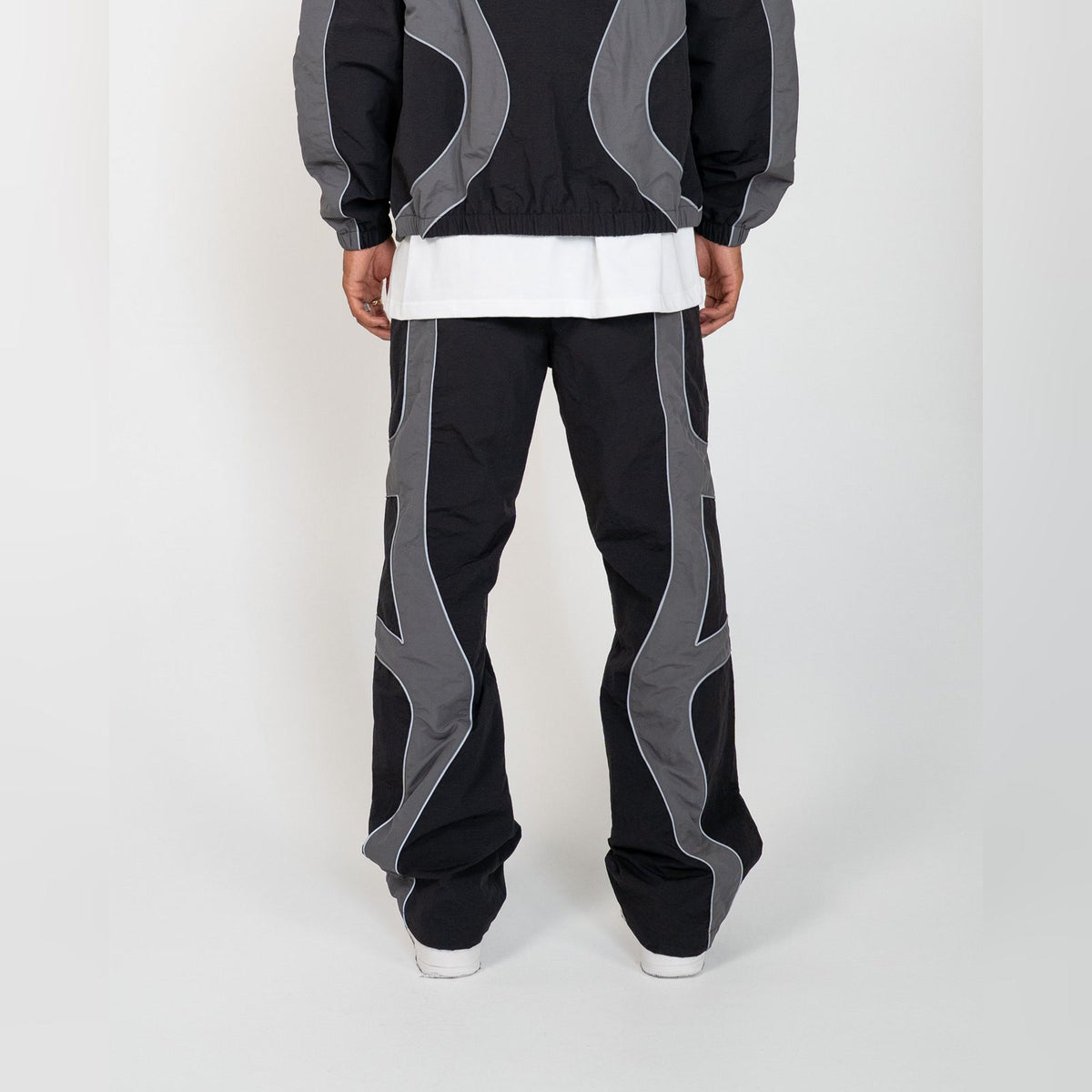 Back of the EPTM Syntax track pants in black, grey contrast panels